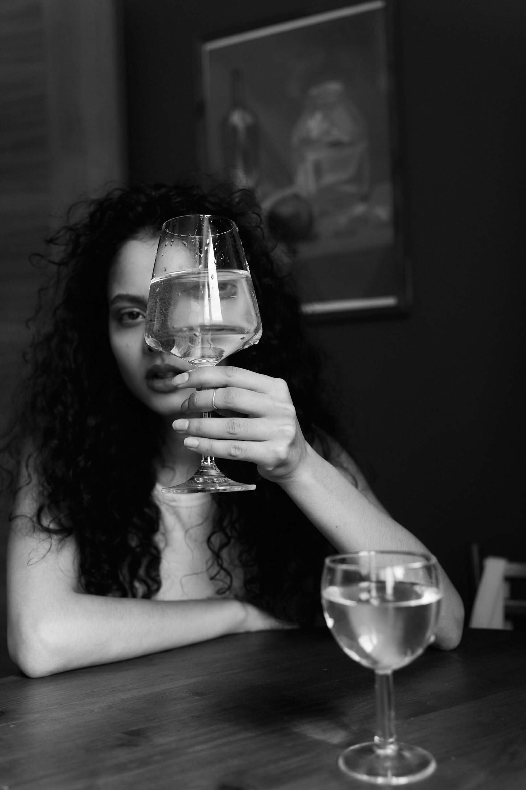 Grayscale Photo of a Woman Holding a Wine Glass
